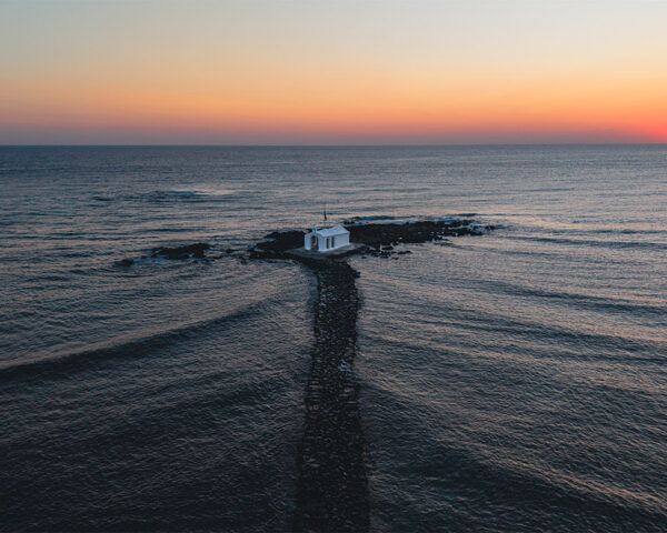 Chapel of Agios Nikolaos at Sunrise, Georgioupoli, Crete Chapel of Agios Nikolaos at sunrise, white chapel on a rocky islet with a stone causeway, Georgioupoli, Crete, Greece