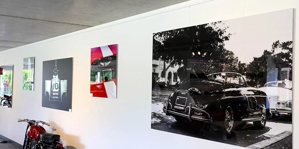 Framed fine art print in a hallway with a black door — Cars and Roses