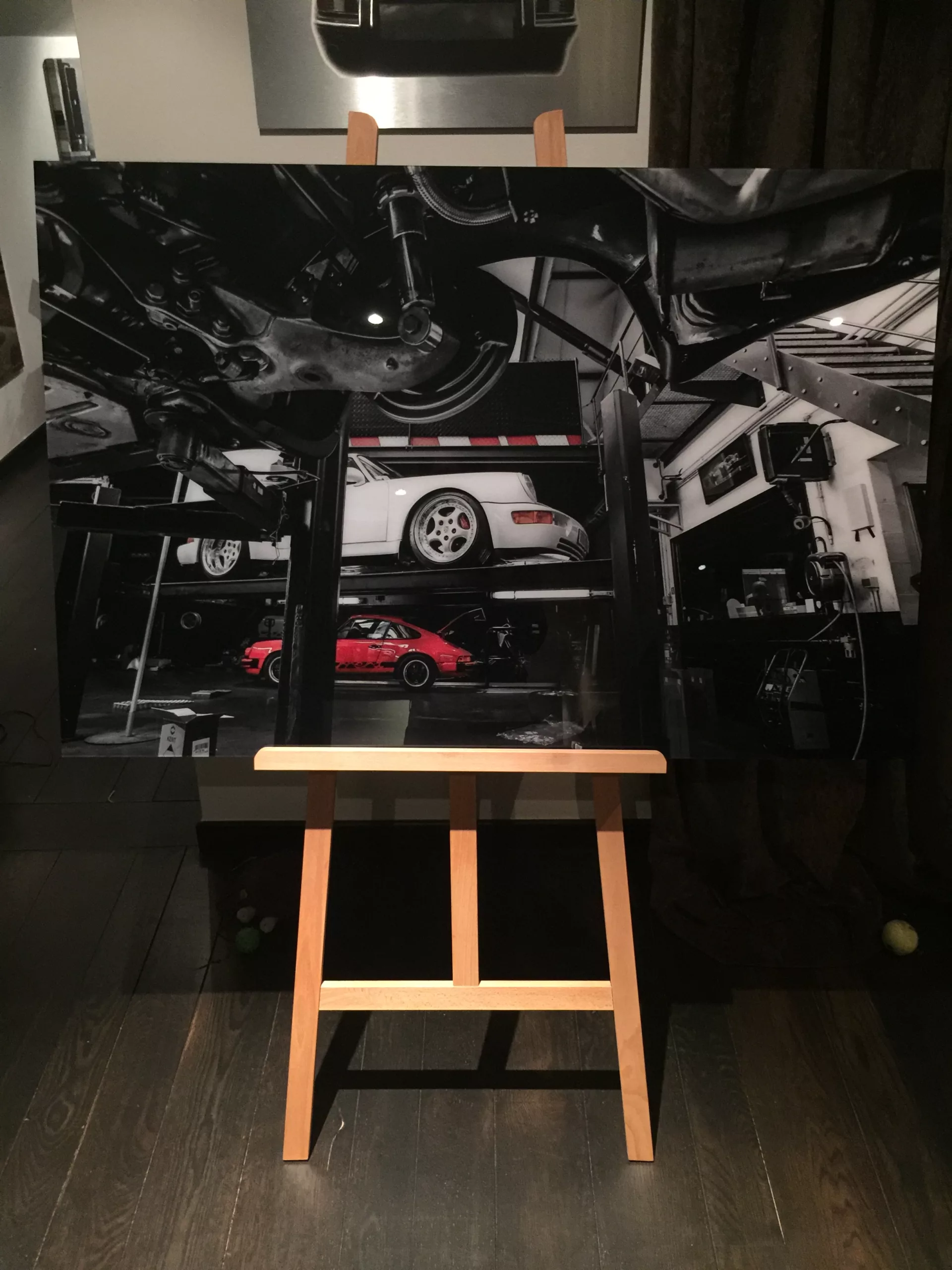 Fine art print being set on an easel — behind the scenes at the Cars and Roses studio