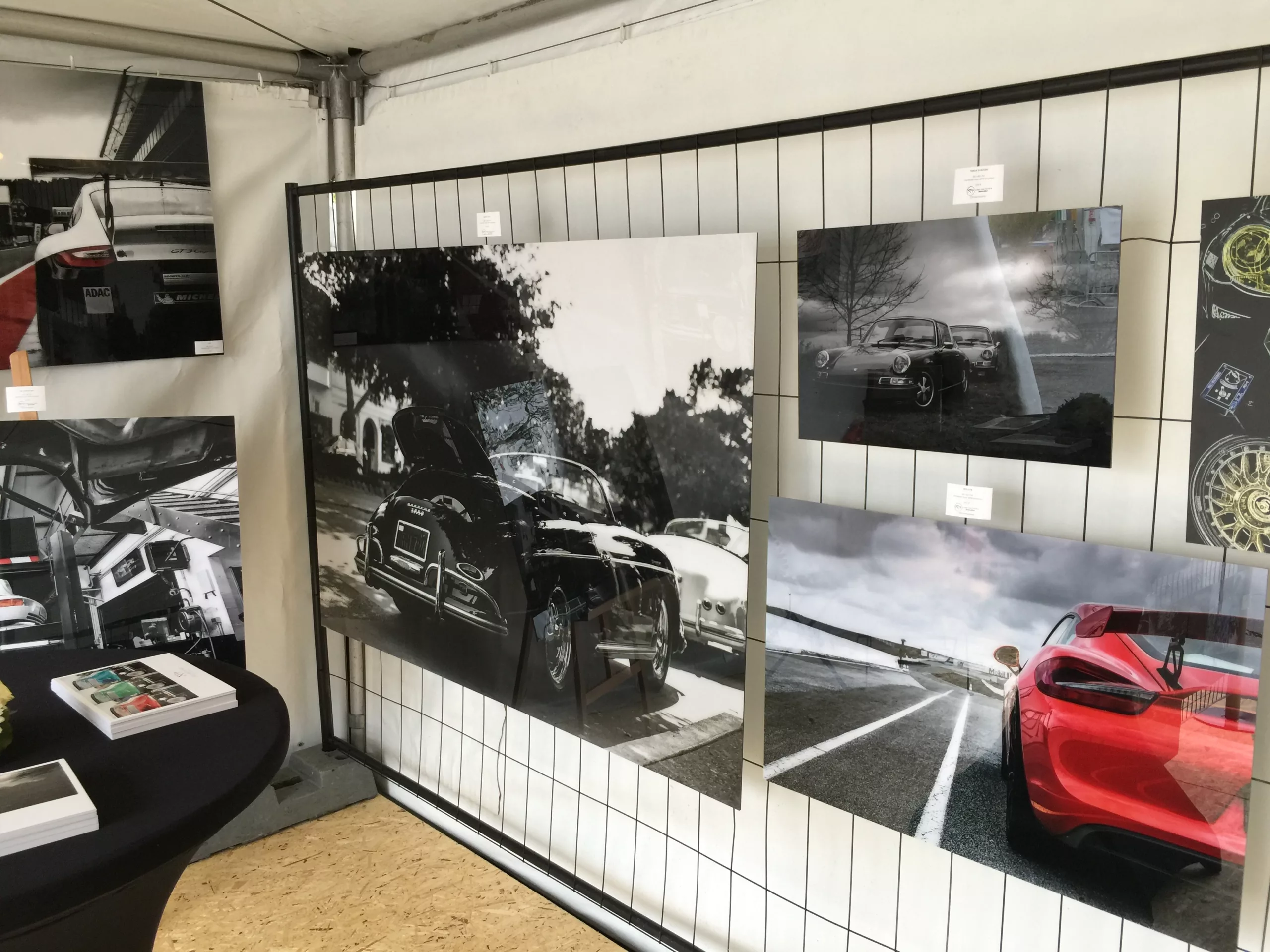 Wall of three black and white fine art car photography prints in a dark interior space — Cars and Roses