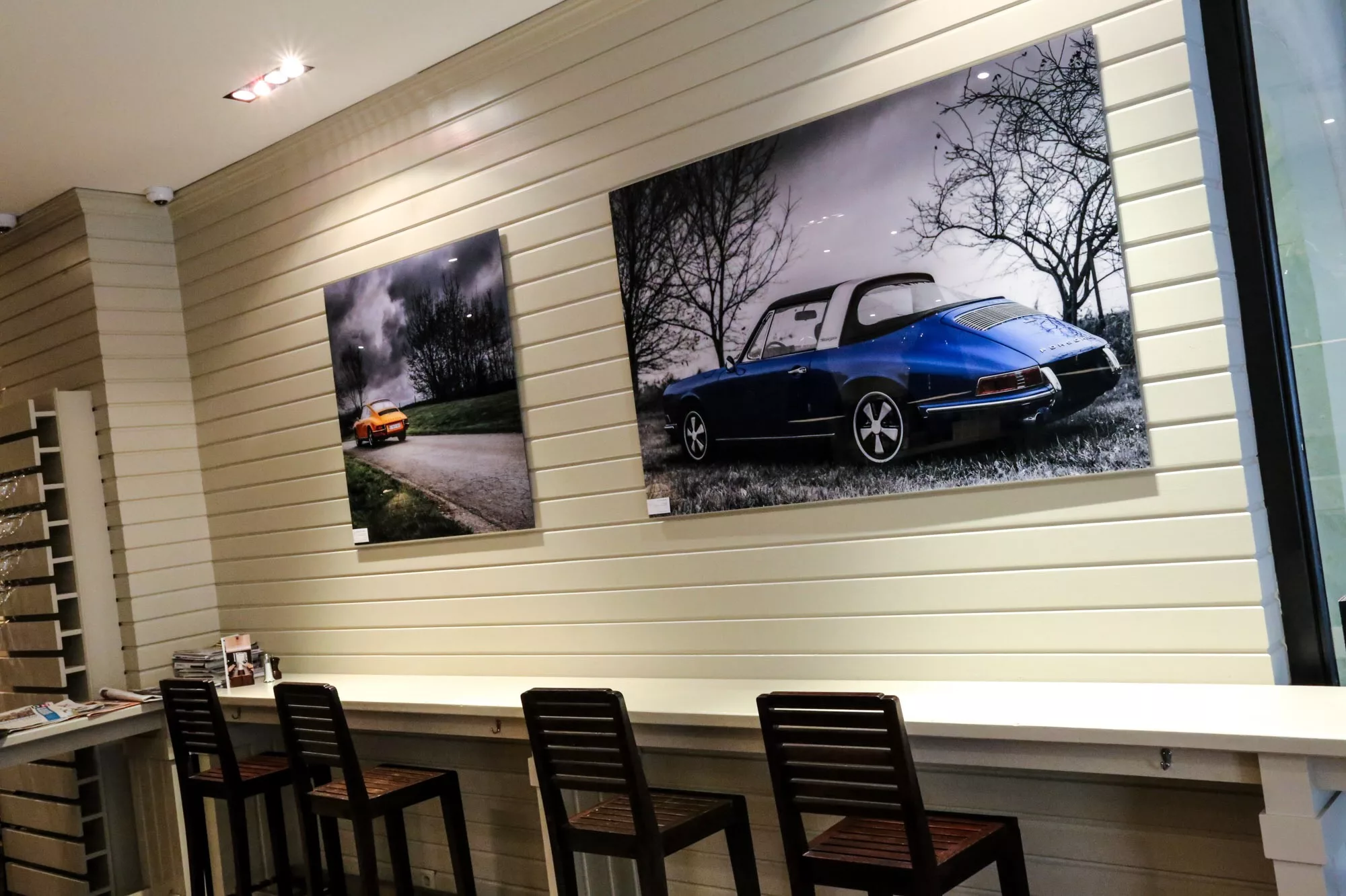 Framed car photography print above a dining table, grey interior — Cars and Roses