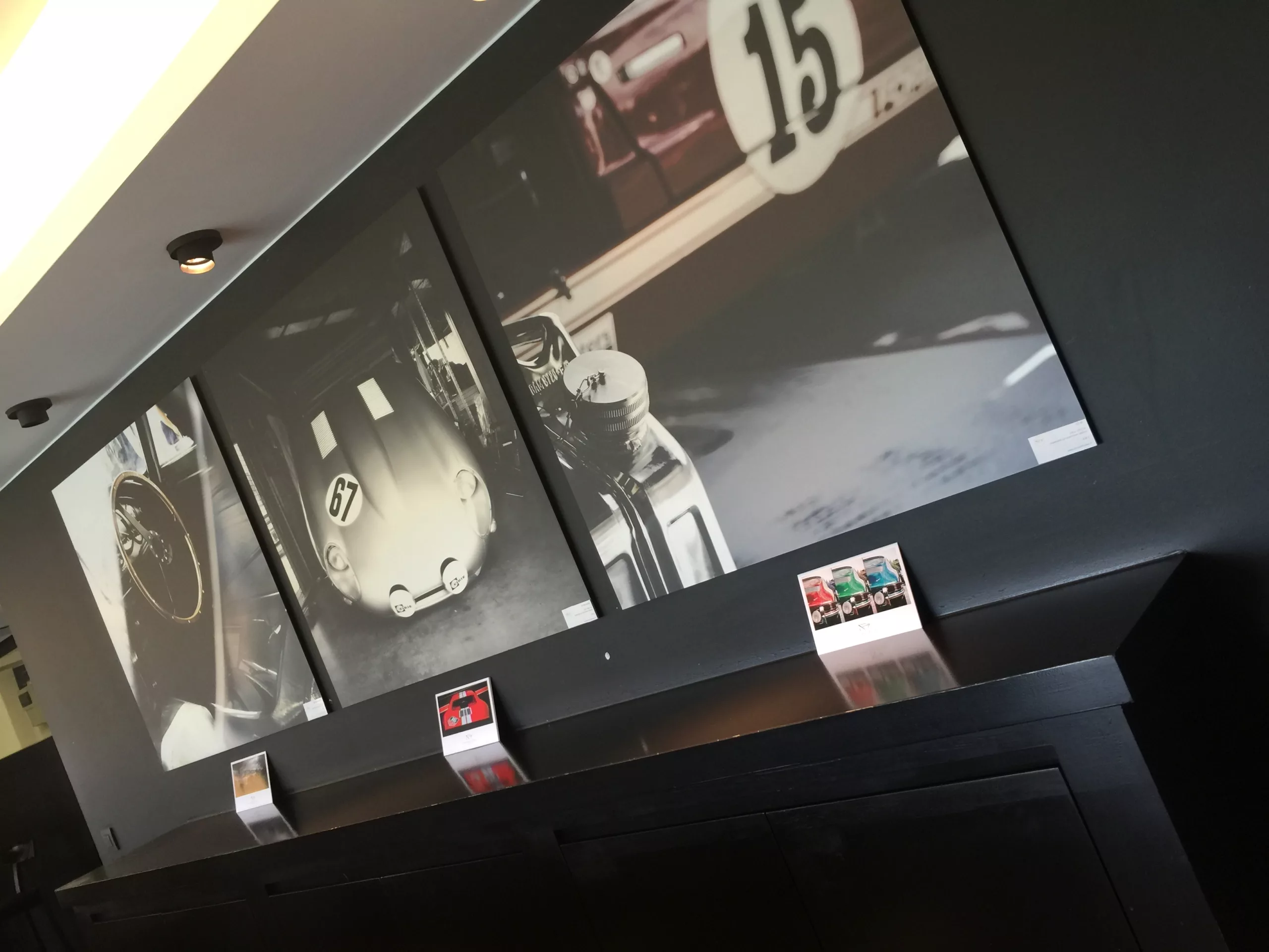 Two black and white fine art car photography prints installed in a dimly lit room — Cars and Roses
