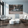 Minimalist living room interior with white brick wall and chairs errari F40 grey art print displayed on large canvas in modern minimalist living room with white brick wall, contemporary furniture and natural lighting