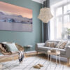 Boho interior design of living room with sofa and rattan armchai Wall decor photography of Jökulsárlón glacier in Iceland showing azure blue icebergs floating on the glacial lagoon under a pink twilight sky, perfect for Scandinavian interior design