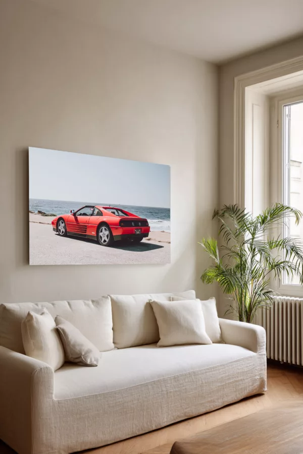 Ferrari 348 TS at Pebble Beach fine art print displayed as wall art above a sofa in a bright living room