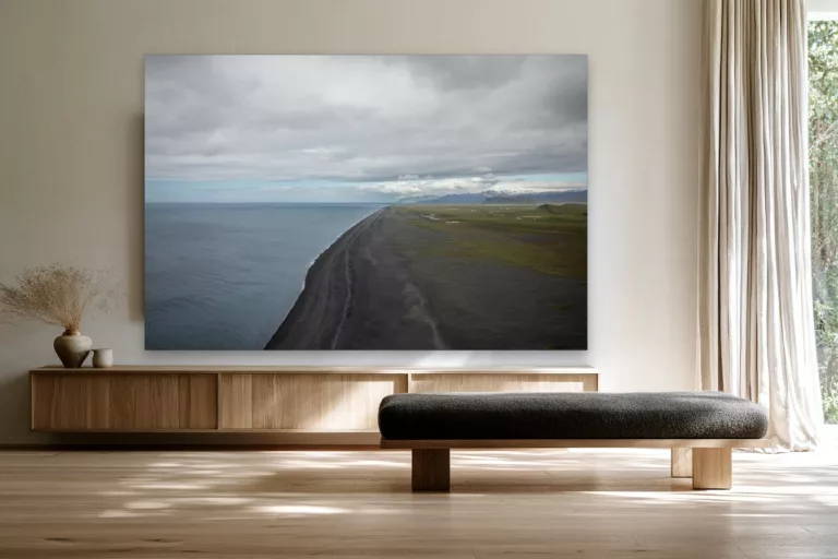 Iceland black sand beach fine art print hanging above a pale oak sideboard in a calm Scandinavian living room