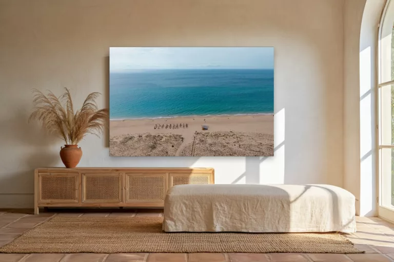 Zahara de los Atunes beach in Spain fine art print hanging above a rattan sideboard in a bright Andalusian living room