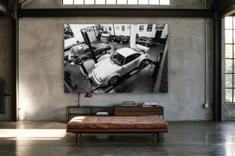Black and white Porsche 911 workshop wall art in an industrial loft