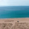 Zahara de los Atunes beach photograph Zahara de los Atunes beach in Spain seen from above, with turquoise Atlantic water, golden sand and dunes