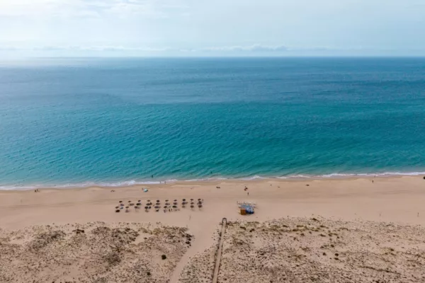 Zahara de los Atunes beach photograph Zahara de los Atunes beach in Spain seen from above, with turquoise Atlantic water, golden sand and dunes