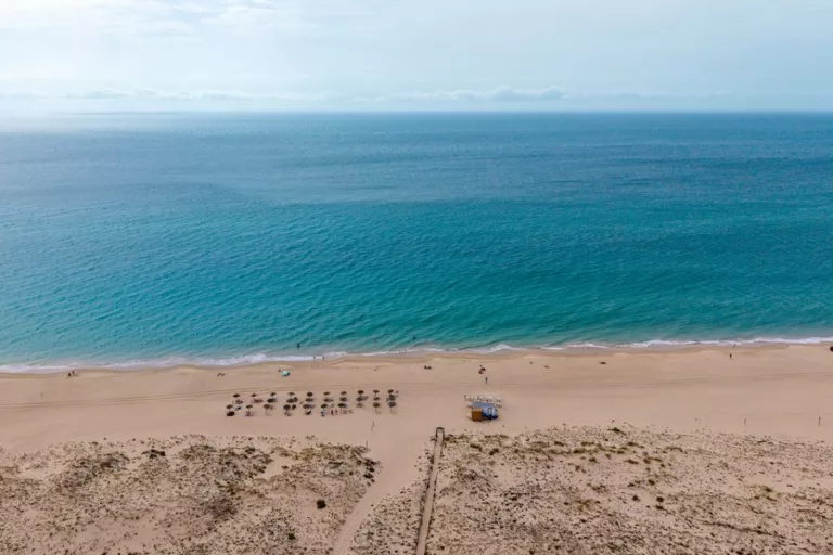 Zahara de los Atunes beach in Spain seen from above, with turquoise Atlantic water, golden sand and dunes